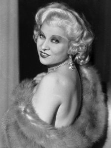Mae West in fur stoal probably with very little underneath.